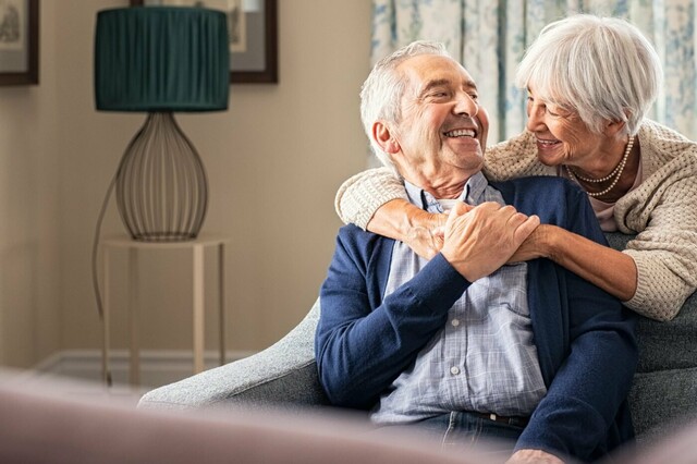 Elderly couple at home looking happy and peaceful 